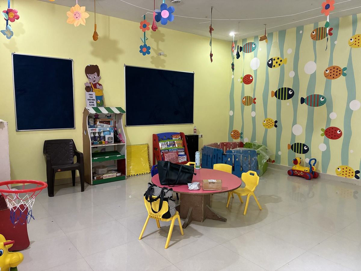 Classroom at Iris Bloom Preschool with an under-the-sea mural, blackboard and activity corner